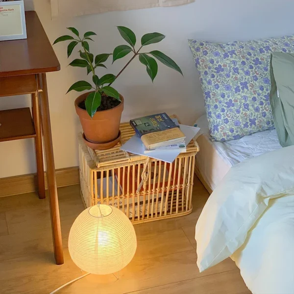 Rijstpapierlamp met drie slanke zwarte metalen pootjes, 21 cm hoog en 23 cm breed, die warm licht verspreidt en past bij Japandi en Wabi Sabi interieurstijl.